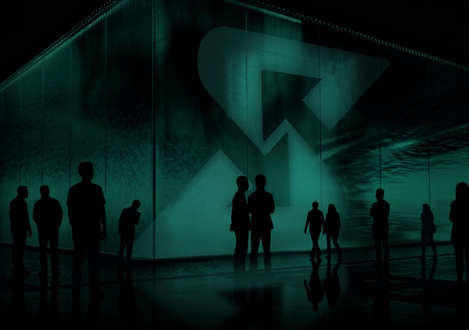 Silhouetted figures standing beside an illuminated glass structure at night